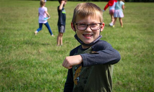 Boy holds out butterfly